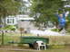 1989 Ford Bronco - A child rides a zip line in a yard with a green trailer and a house in the background.