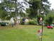 1989 Ford Bronco - A backyard scene with children enjoying a zipline and a toy car, with a trailer in the background.