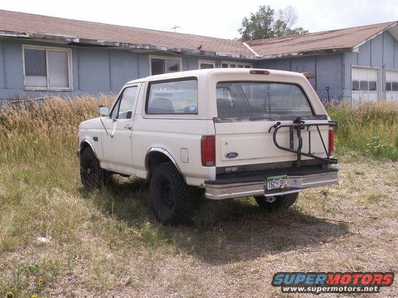 White 1992 Ford Bronco rear view with spare tire carrier