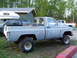 1984 Chevrolet Blazer - A weathered pickup truck sits outdoors next to other vehicles and a building.