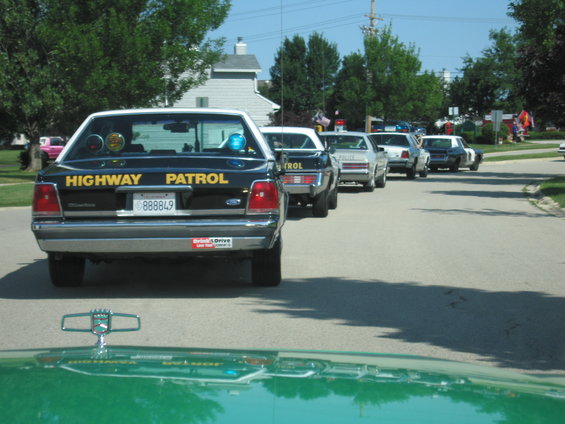 1991 Ford Crown Victoria Highway Patrol car rear view, followed by other police cars