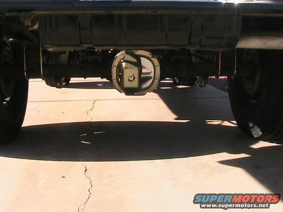Rear differential and suspension components of a dark-colored vehicle, viewed from underneath