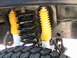 1985 Ford Bronco - A view of the front suspension system, including shocks and springs, on a vehicle.