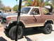 1985 Ford Bronco - This 1985 Ford Bronco features a two-tone brown and tan paint scheme with prominent side trim.