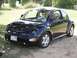 1999 Volkswagen Beetle - This 1999 Volkswagen Beetle is seen from a three-quarter front view, parked on a dirt lot.