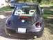 1999 Volkswagen Beetle - The rear view of a black Volkswagen Beetle shows its distinctive taillights and a Texas license plate.