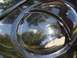 1999 Volkswagen Beetle - Close-up of a black headlight, reflecting the surrounding environment.