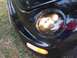 1999 Volkswagen Beetle - Close-up of a 1999 Volkswagen Beetle's front corner, showing the headlight and turn signal.