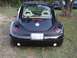 1999 Volkswagen Beetle - Rear view of a black 1999 Volkswagen Beetle showing its distinctive taillights and license plate.