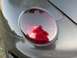 1999 Volkswagen Beetle - Car taillight detail, reflection of photographer visible.