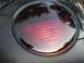 1999 Volkswagen Beetle - Close-up of a round red taillight assembly.