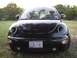 1999 Volkswagen Beetle - Front view of a black 1999 Volkswagen Beetle parked outdoors.