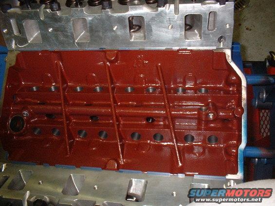 Close-up of a red engine block with a silver cylinder head attached