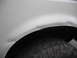 1991 Ford Bronco - Scratches and dirt are visible around the wheel well of this white vehicle.