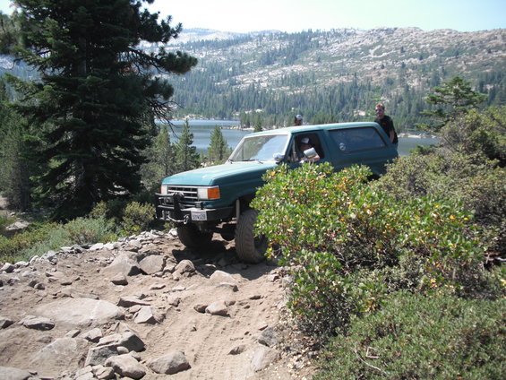 Green 1991 Ford Bronco on a rocky trail, 3q-front view. License plate reads 5PNU29