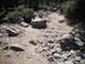 1991 Ford Bronco - Vehicles traverse a challenging rocky trail in a wooded area.