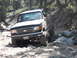 1991 Ford Bronco - This 1991 Ford Bronco is shown tackling a challenging off-road course with large rocks.