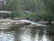 1991 Ford Bronco - A natural scene of a river flowing over rocks in a forested area.