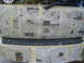 2004 Dodge Durango - Newspaper covers the rear of a vehicle, likely for protection during a paint job.