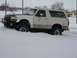 1990 Ford Bronco - This 1990 Ford Bronco is stuck in a snowy ditch with its front tires buried.