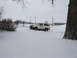 1990 Ford Bronco - A white Ford Bronco is stuck in a snow-covered field with its front end buried.