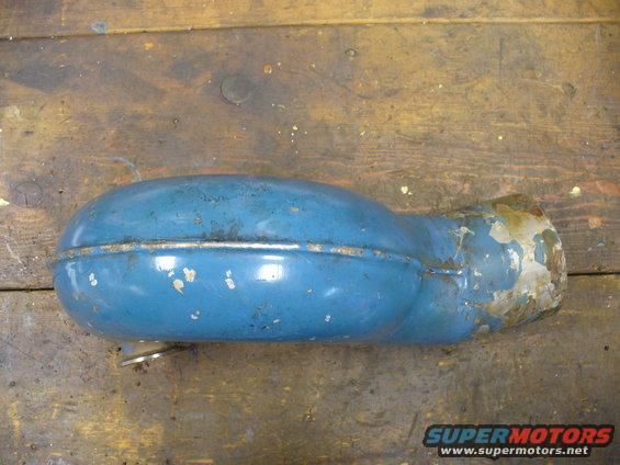 blue exhaust silencer with rust and chipped paint, on a wooden surface