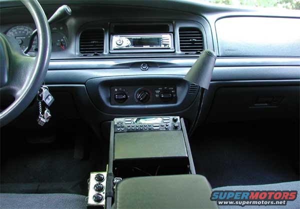 Scanner, Head Unit, Tri-Outlet, Red Map Light, Stainless Gerber 9-In-1 Tool, Remote Bass Boost Controller (Below Tri-Outlet, not pictured), Mag-Lite (Attached to side of arm rest)