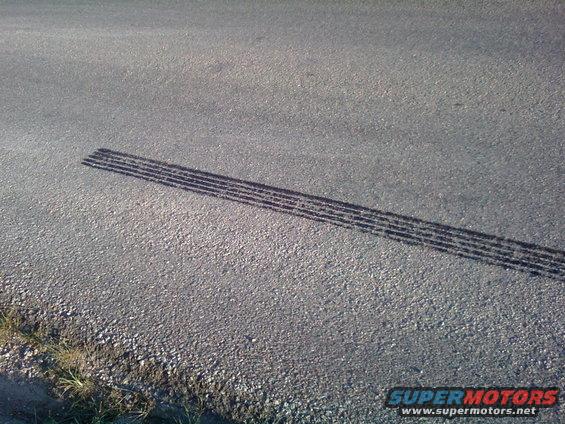 Tire tracks on a paved road surface