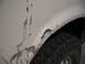 1991 Ford Bronco - Muddy fender and tire on a white vehicle, showing signs of off-road use.