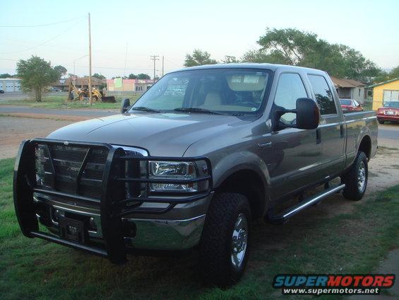 Gray Ford F-250 Super Duty pickup truck with a black brush guard and chrome side steps