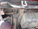 1991 Ford Bronco - Close-up of the undercarriage, revealing suspension parts and a fuel tank.