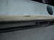 1991 Ford Bronco - This image shows a portion of a vehicle's exterior, focusing on the bumper and a protective rock slider.