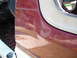 1991 Ford Bronco - Close-up of a 1991 Ford Bronco's maroon door jamb and interior floor, revealing scuff marks and the gas pedal.