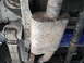 1991 Ford Bronco - The underside of a vehicle shows the exhaust system and a blue filter, with visible mud and rust.