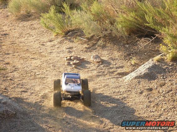 RC crawler truck driving on a dirt path