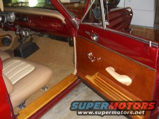 red car interior, tan seats, wood paneling on door, "SUPERMOTORS www.supermotors.net" watermark