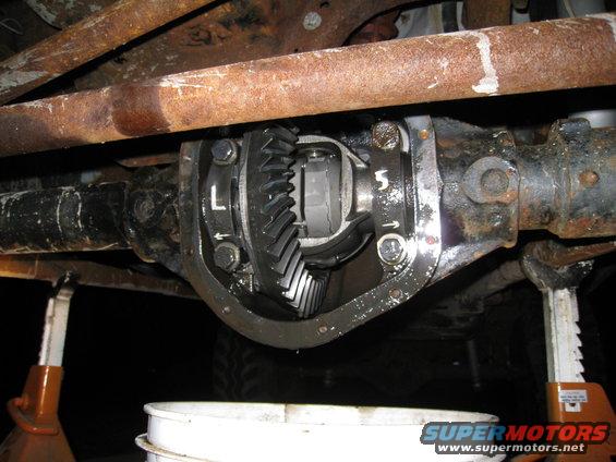 Differential cover removed showing gears, with 'L' and '5' markings