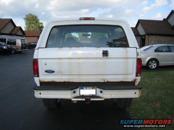 White 1996 Ford Bronco rear view with rust stains and a Ford badge