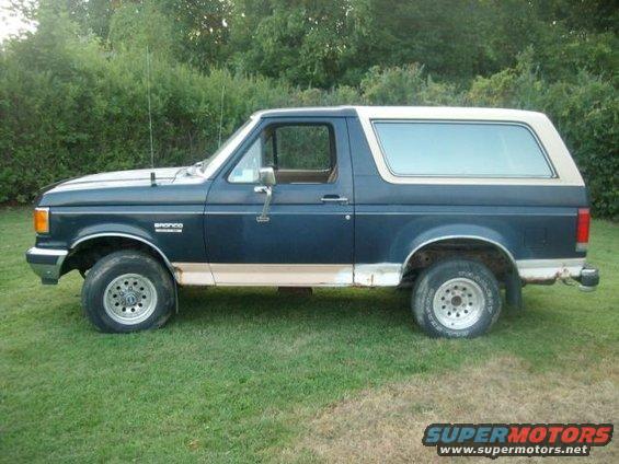 1987 Ford Bronco parked on grass, side view