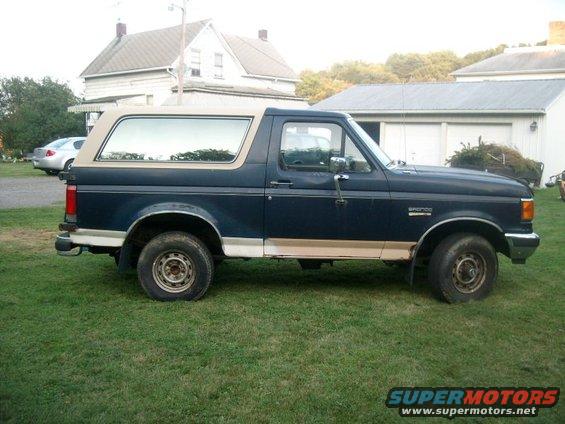 1987 Ford Bronco parked on grass, side view
