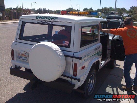 White Ford Bronco SUV with Sheriff Search & Rescue markings, spare tire on rear, emergency lights on roof