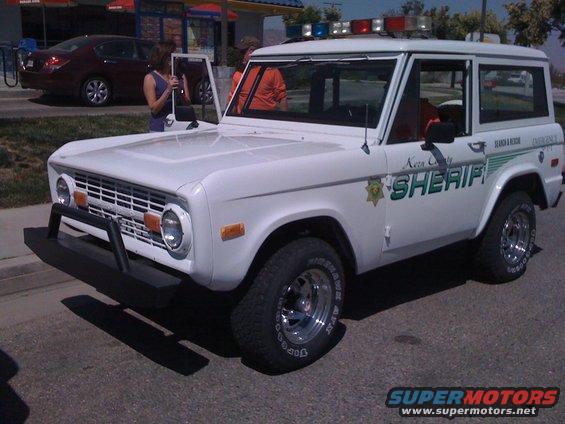 White Ford Bronco with 'Kersa County SHERIFF' text and emergency lights