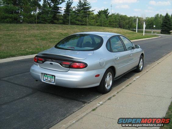 Silver sedan parked on a street, rear view. License plate reads DJN N40