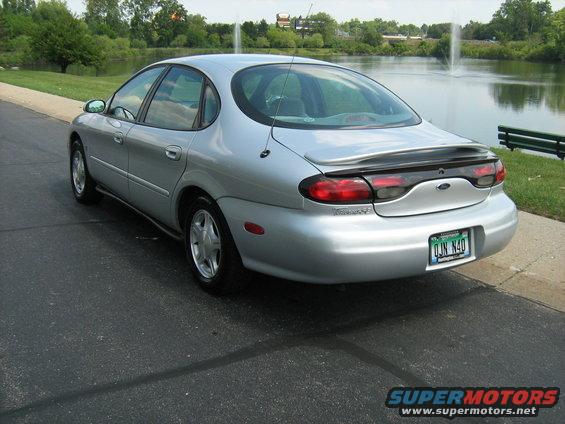 Silver sedan rear view with spoiler and license plate