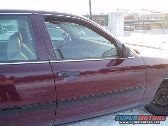 maroon sedan side view, showing door handle and part of interior