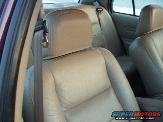Interior view of tan leather seats and seatbelt