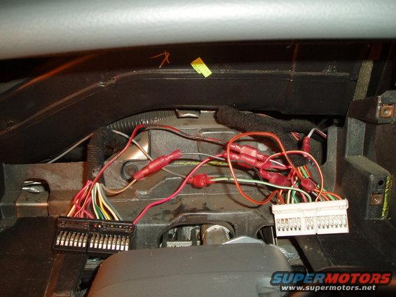 fully connected, notice tach wire coming up from the left, connected to the light green/white wire in the white connector and the white/red wire going down to be wired into the marauder gauge pod. also used two T-taps for the dupe wires.

** there are other ways of wiring it up, i liked this way, just in case i had to go back to the original cluster, it would have been easy to do.