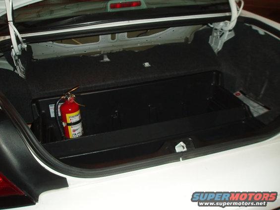 Open trunk with a red bottle inside