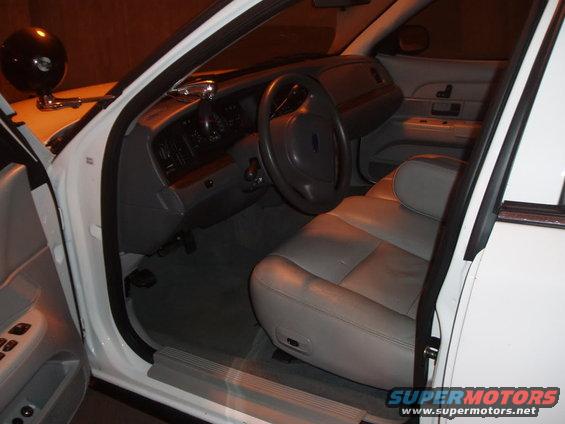 Car interior showing front seats and dashboard through open doors