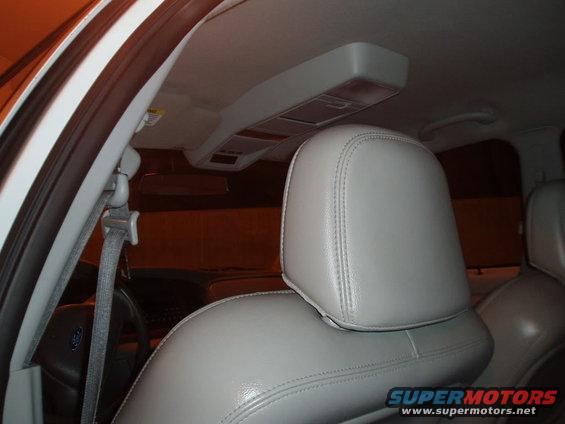 Interior of a car showing a white headrest and part of a seat